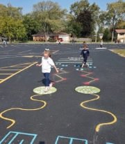 Because recess was restricted to specific cohort areas, the 8th grade students painted new games across the play areas for all students to enjoy.